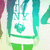 Pixelated icon shows a figure in green pants and a white top with a teal heart symbol on the chest, framed by teal vertical borders.