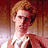 Pixelated image of a person with light brown hair and white clothing against warm-toned background, accompanied by yellow text phrases.