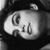 Pixelated grayscale icon of a rounded animal head with large eyes and a small nose, set against a dark background.