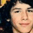 A pixelated image shows a person with dark hair on the left and a blue background with '03' in white pixelated numbers on the right.