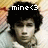 Pixelated image of a person with dark hair and light skin, overlaid text reading 'mine<3' in white block letters against a blurred background.