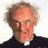 A pixelated image of a person with light brown hair and a dark shirt, with text below reading ARSE! and GIRLS! in repeated