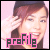 A pixelated image of a person with brown hair and a dark headband, smiling while holding hands near their face against a pink background.