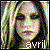 Pixelated image of a person with light-colored hair and dark eyes, wearing a dark top, with text 'awil' at the bottom right.