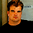 A 48x48 pixel buddy icon featuring a person in a black shirt with text and a remote control graphic, displayed as part of an animated contact sheet.
