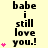 Yellow background with black text reading "babe i still love you!" and pink heart symbols in a vertical arrangement.