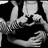 Black-and-white animation of two figures in a close embrace, one figure's hand moves from the other's shoulder to their back across frames.