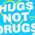 Blue background with white text reading HUGS NOT DRUGS, yellow heart symbols, and curved lines forming partial circles around the text.