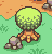 Pixel art of a green spherical tree with brown roots and yellow spots, standing on light green grass next to a gray rock under an orange sky.