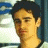 Pixelated image of a person with dark hair against a blurred background, next to green text reading 'OriginalIcons.com' on a solid dark green field.
