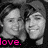 Two grayscale faces in close-up, side-by-side with a black background and pink text reading 'love.' at the bottom left.