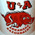 Red cartoonish creature with large eyes and sharp teeth, positioned below stylized red 'U' and 'A' letters on a light background.