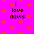 Pixelated icon with bright pink background, red hearts scattered throughout, and repeated text "i love davis" in black pixel font.