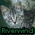 Pixelated image of a light gray cat with dark eyes and nose, positioned against a muted greenish-gray background, with the word 'Riverwind' in green block letters at the bottom.