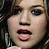 A 4x4 contact sheet of a pixelated animated icon featuring Kelly Clarkson's face and yellow text phrases on black background with heart symbols.