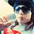 A three- animated sequence shows a person in a dark helmet and sunglasses making gestures against a blurred background, with red text below reading "Leigh Loves Tom"