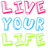 Pixelated text in pink, blue, and green reads "LIVE YOUR LIFE" on the left; black-and-white blocky text says "Not Some One Else" on the right with scattered red and gray pixels.