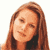 Static pixelated image of a person with long brown hair and light skin tone, cropped to show upper shoulders and head against white background.