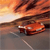 A pixelated image of a red car on a road at sunset with orange and yellow sky, dark clouds, and a white line on the road.