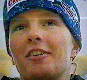A person wearing a blue headband with white text and patterns, shown in six with varying facial expressions and lighting conditions