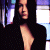 A pixelated image of a person with long dark hair in a black top, positioned next to green text reading "Original Icons .com" on a solid background.