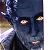 Pixelated close-up of a dark-skinned figure with glowing yellow eyes and mouth, wearing a black hooded garment against a blurred background.