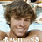 Pixelated static image of a person with curly brown hair, light skin tone, and visible facial features including eyes, nose, mouth, and chin.