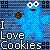 Pixelated blue Sesame Street character holding a cookie with text "I Love Cookies" on a blue pixel grid background.