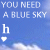 A blue sky background with white text reading 'YOU NEED A BLUE SKY' and a growing word below that forms 'holiday', accompanied by a small white heart icon.