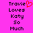 Pixelated text on bright pink background with red heart symbol replacing 'i' in 'Travie', repeated twice side-by-side.