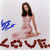 Pixelated image of a woman in a pink dress with long dark hair, blue abstract symbol, and brown text reading 'LOVE' at bottom.
