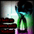 Pixelated image of a figure with dark hair and blue-green glowing aura, standing before a bright light source with red text blocks on the left.