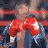 Animated sequence of a boxer in red gloves and blue jacket, fists raised in front of blurred crowd background.