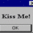 A pixelated interface with blue top bar, gray background text reading 'Kiss Me!', and a button labeled 'OK' below.