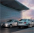 Two cars on a road under a large overpass with a sky background, rendered in low-resolution pixel art style.