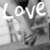 A grayscale static icon displays the word 'Love' in large white letters above a smaller, partially obscured text element on a pixelated background.