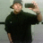 A person in a dark shirt and hat holds a phone up to take a photo, with slight variations