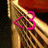 A four- shows a golden curved object with red and black background, featuring a heart-shaped outline that changes color