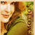 A pixelated image shows a person with light skin and brown hair wearing a green top, with vertical text on the right side.