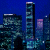 Static pixelated image of a nighttime cityscape with multiple skyscrapers against a dark blue background.
