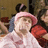 Pixelated image of a person in a pink hat and white shirt on a pink background with red text reading "I wonder if I would Look more MANLY If I Stopped Wearing PINK!".