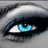 A close-up of a stylized eye with blue-green irises, black eyeliner, and white highlights on the sclera against a gray background.