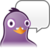Pixelated purple bird-like figure with large white-ringed eyes and orange beak, next to empty white speech bubble on gray background