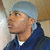 A person wearing a light blue durag and dark blue hoodie with white undershirt, shown in four of animation