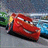 A red anthropomorphic race car with white headlights and black eyes is positioned on a gray road, facing right, with blurred green foliage and blue sky in the background.