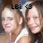 Two pixelated faces with light skin tones and short hair, one wearing a white top; black text 'LEi' and a heart symbol above them on a blurred background.