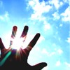 A hand silhouette with fingers spread against a bright blue sky with scattered white clouds, the sun's rays visible through the gaps between fingers.