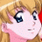 A pixelated anime-style character face with blonde hair and blue eyes on the left, next to a black background with white text reading "Anime IM" and "COM" in stylized fonts on the right.