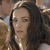 A static pixelated image shows a person with long dark hair and light skin, wearing a light-colored top with a dark strap visible on the shoulder.