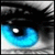 A close-up of a stylized eye with blue and white gradient iris, black pupil, and dark eyelid against gray background.